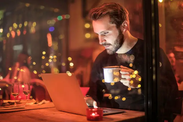 man surfing internet at a café