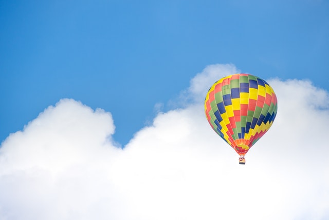 hot air balloon floating in clouds