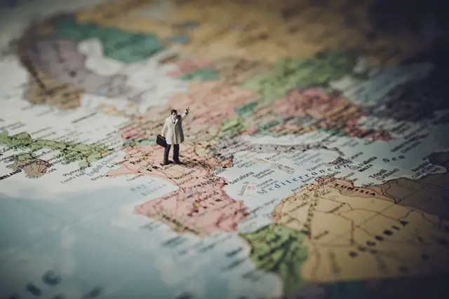 a man miniature on a map