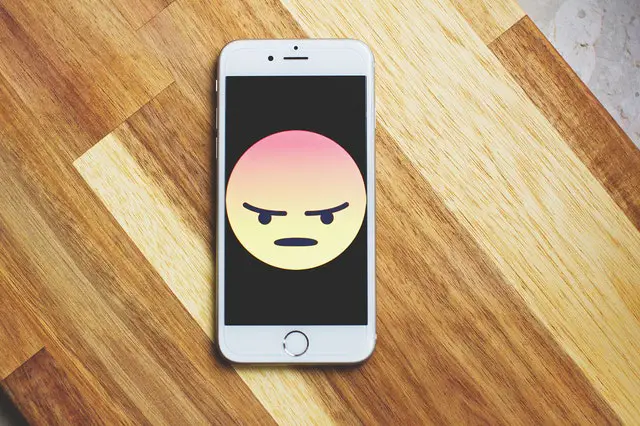 angry emoji on a phone screen