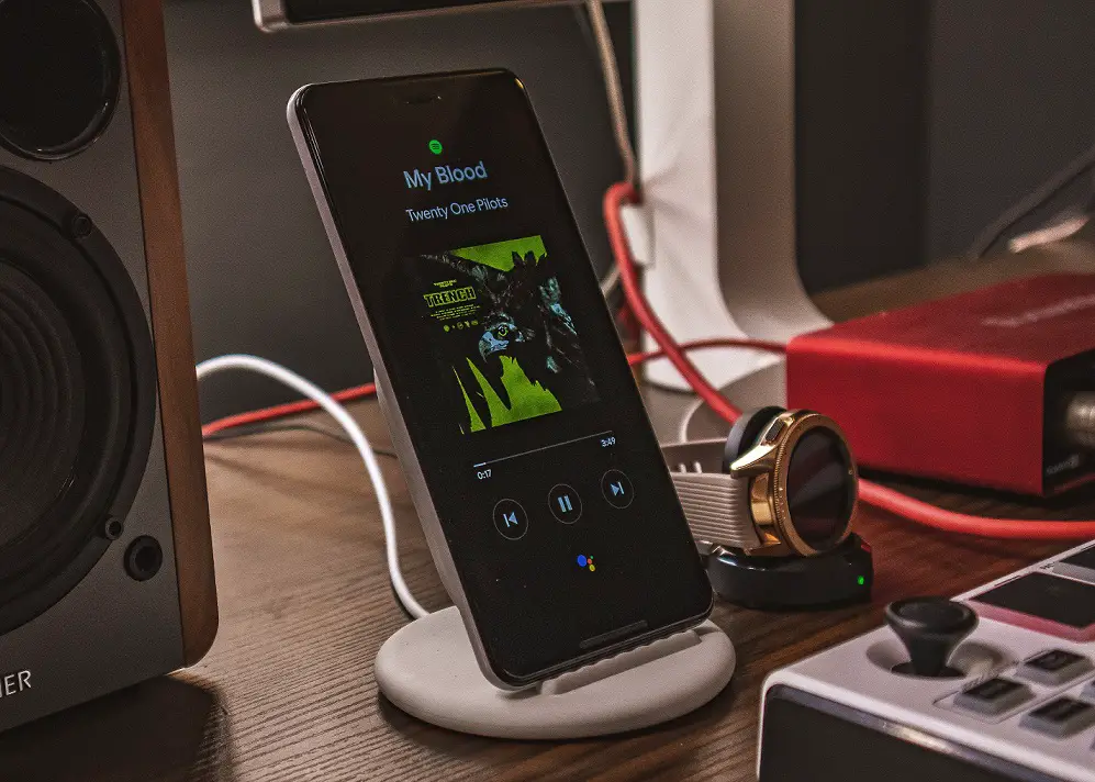 A smartphone playing music on speakers