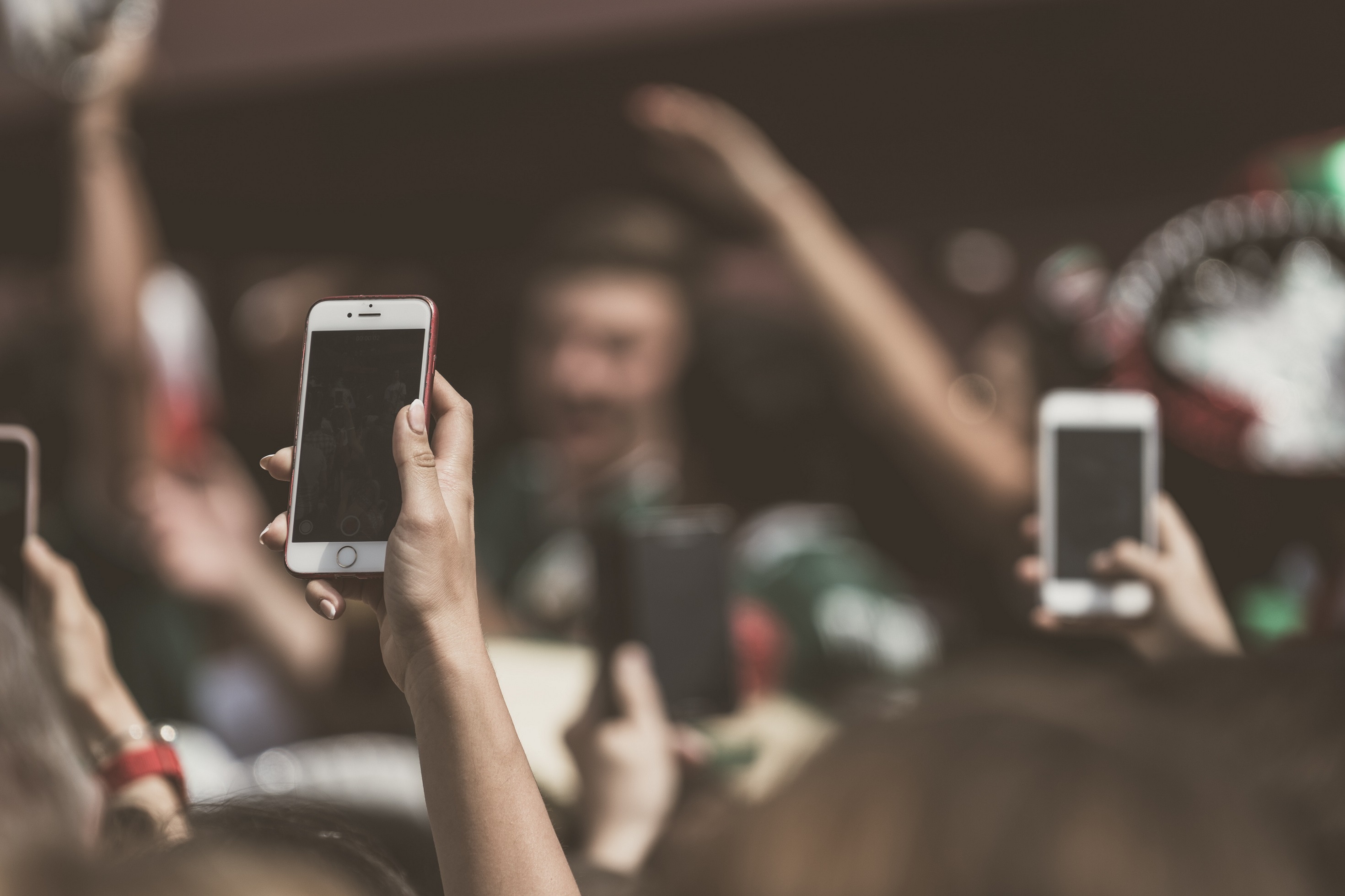 People holding smartphones.